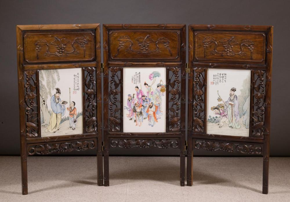 Appraisal: THREE-PANEL ENAMELED PORCELAIN AND CARVED ROSEWOOD FLOOR SCREEN Chinese late