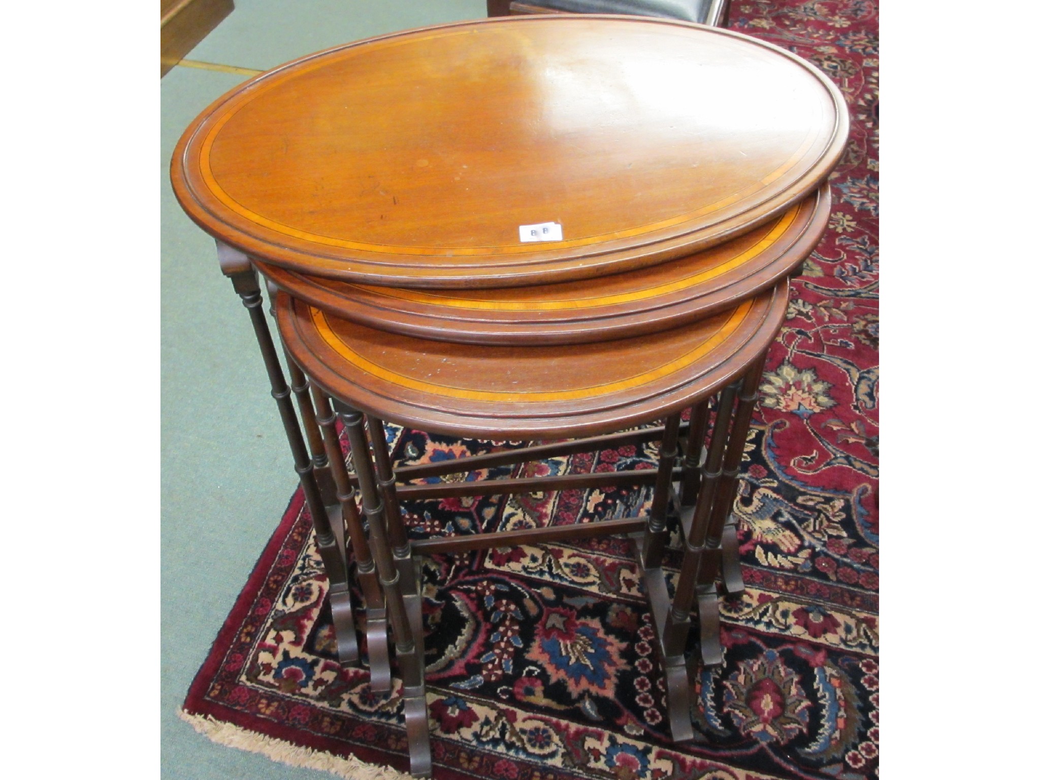 Appraisal: An Edwardian nest of three mahogany oval inlaid tables