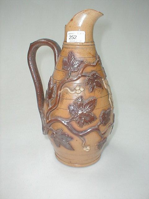 Appraisal: An th century banded stoneware ewer moulded in relief with