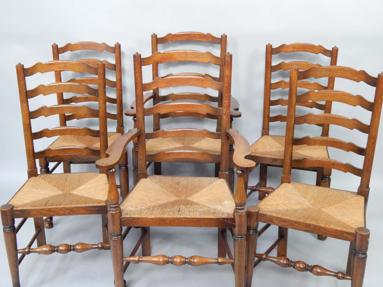 Appraisal: A set of six oak ladderback dining chairs with rush