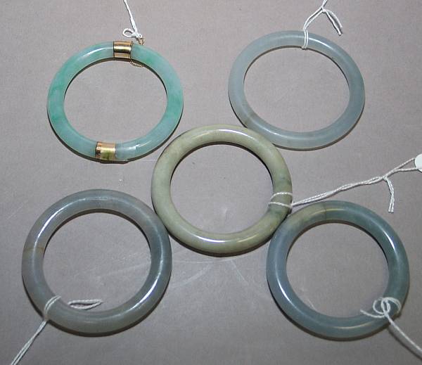 Appraisal: A group of five jade and agate bangles Three of