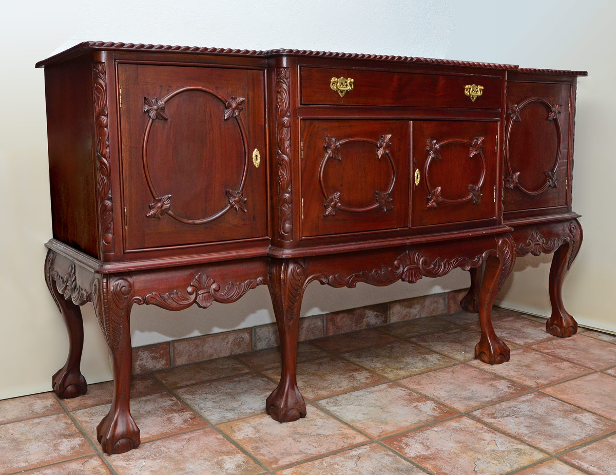 Appraisal: CARVED MAHOGANY SIDEBOARD Contemporary shaped top with rope twist border