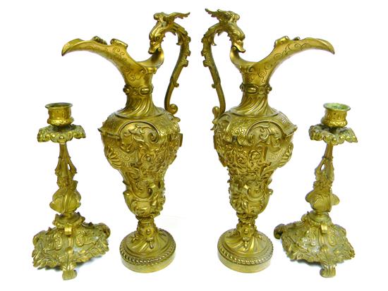 Appraisal: Pair bronze ewers winged serpent handles elaborate scroll and fruit