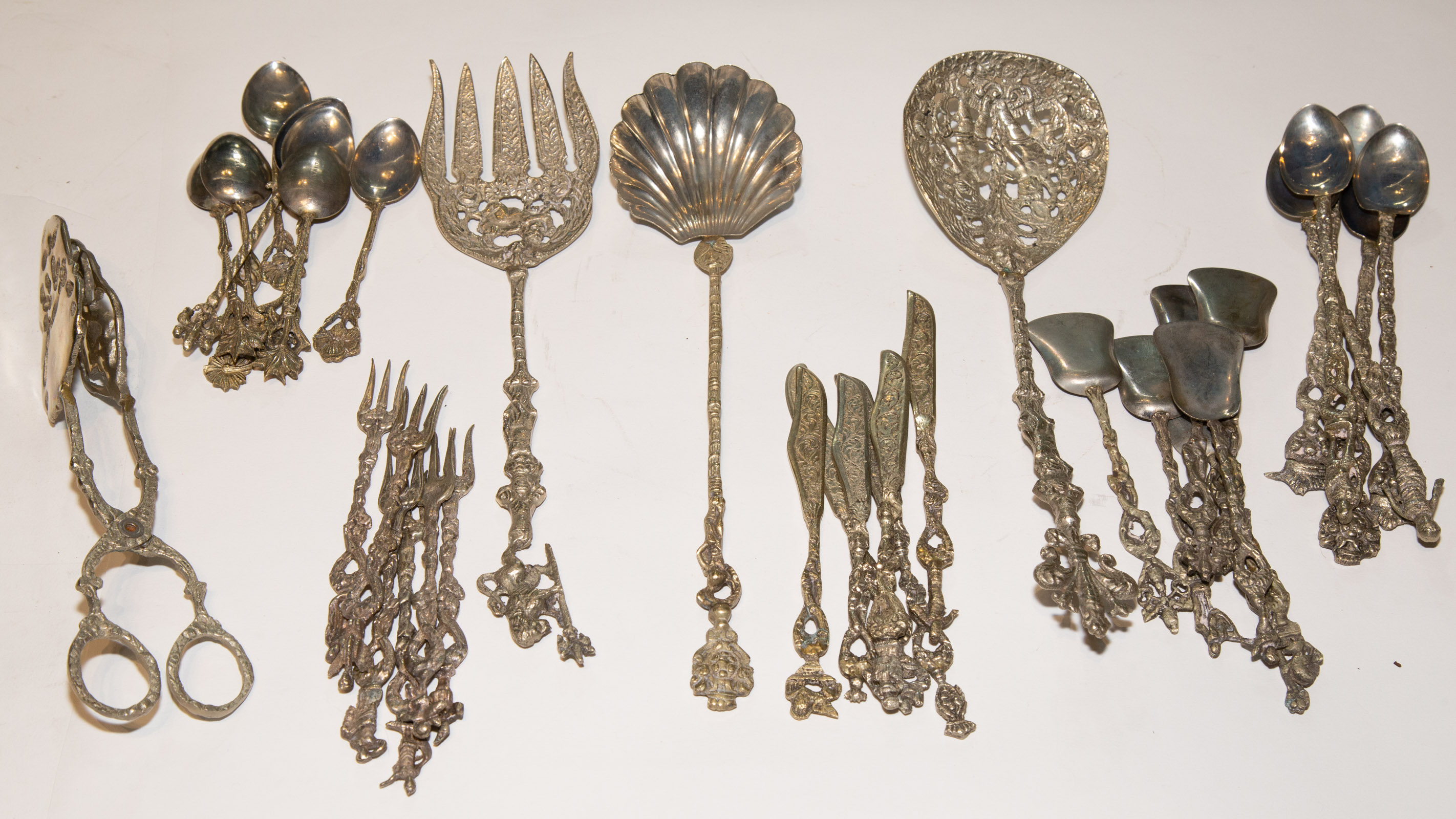 Appraisal: COLLECTION ITALIAN GILT SILVER PLATED FLATWARE With decorative figural terminals