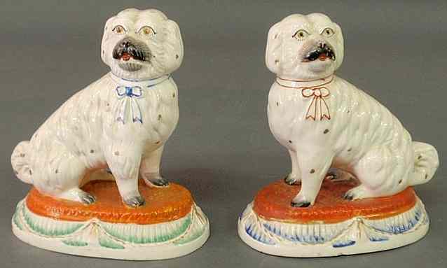 Appraisal: Pair of th c Staffordshire seated dogs on alternating blue