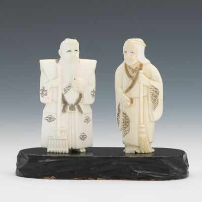 Appraisal: A Carved Ivory Couple with Broom and Rake Carved ivory