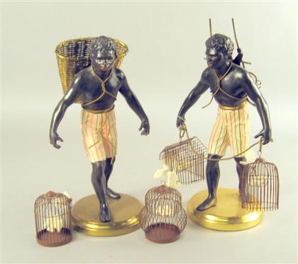 Appraisal: Pair of polychrome and patinated metal Blackamoors Each standing holding