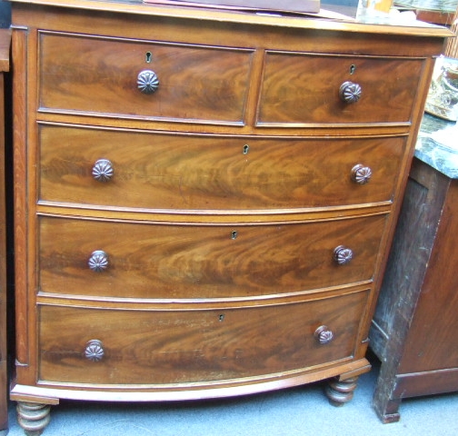 Appraisal: A late Regency mahogany bowfront chest of two short and