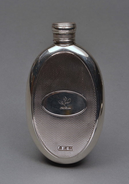 Appraisal: A VICTORIAN SILVER OVAL HIP FLASK with acorn crest and