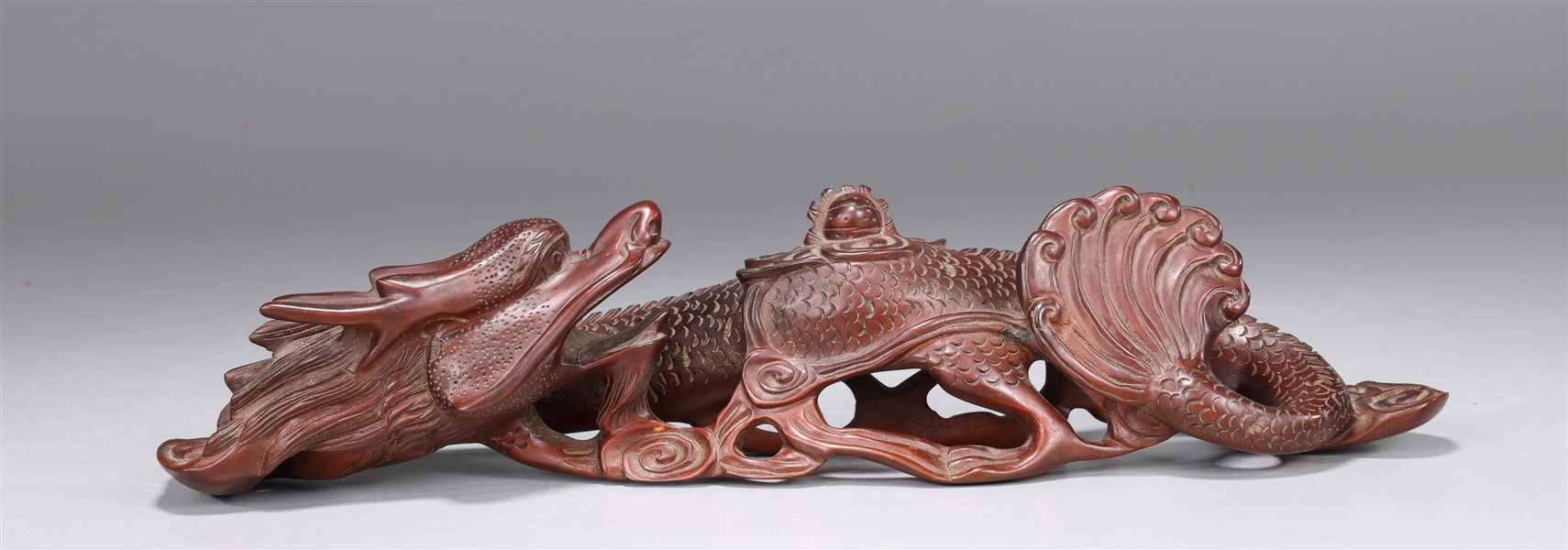 Appraisal: Chinese wood carving with openwork water dragon amid clouds incised