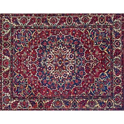 Appraisal: PERSIAN BAKHTIARI Room-size hand-knotted rug geometric floral design on garnet