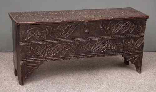 Appraisal: A th Century oak plank coffer later carved with leaf