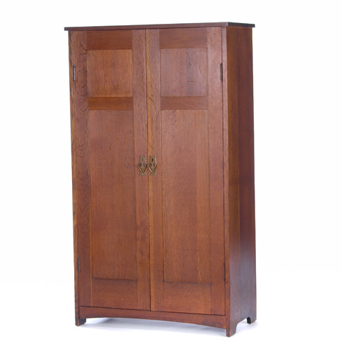 Appraisal: GUSTAV STICKLEY Child's wardrobe with two paneled doors interior drawers