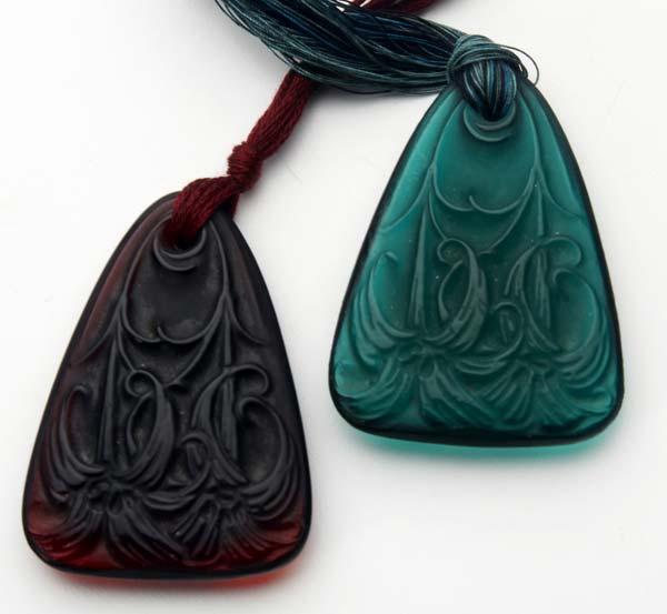 Appraisal: RENE LALIQUE Two Lys pendants of teal and dark amber