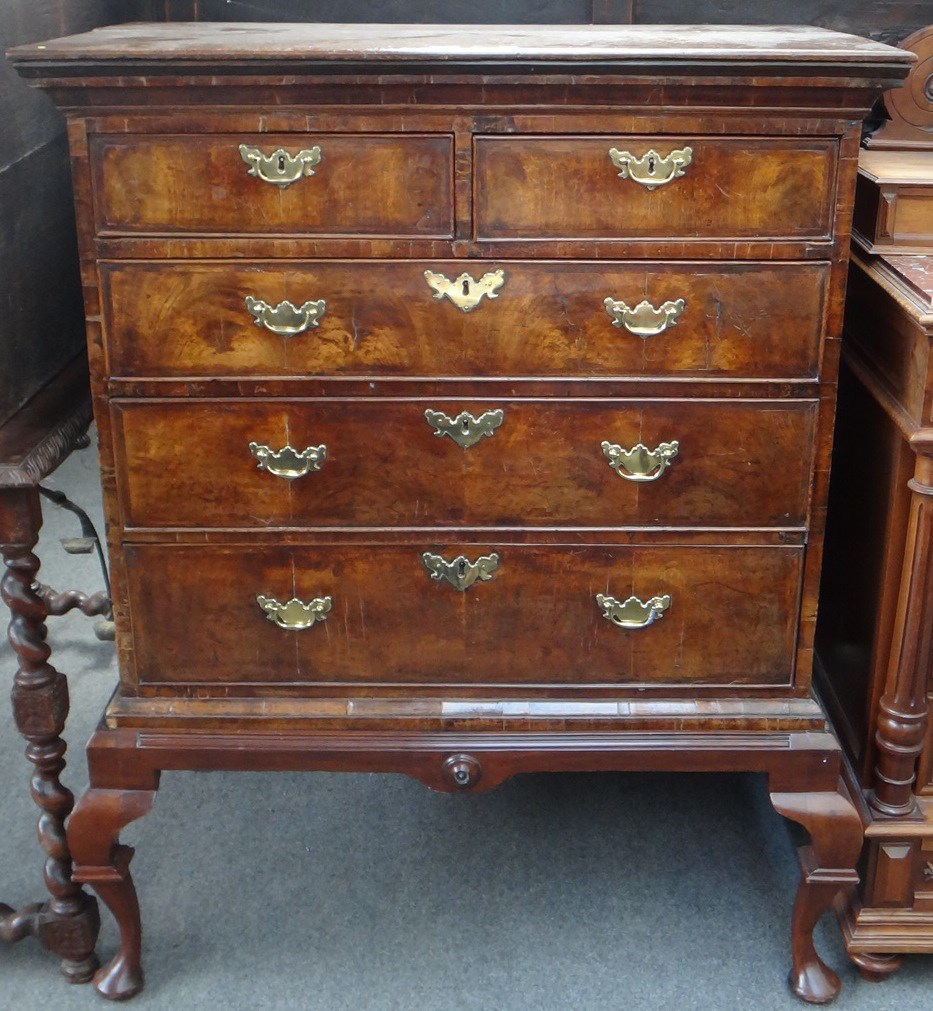 Appraisal: A George I figured walnut chest on stand with two