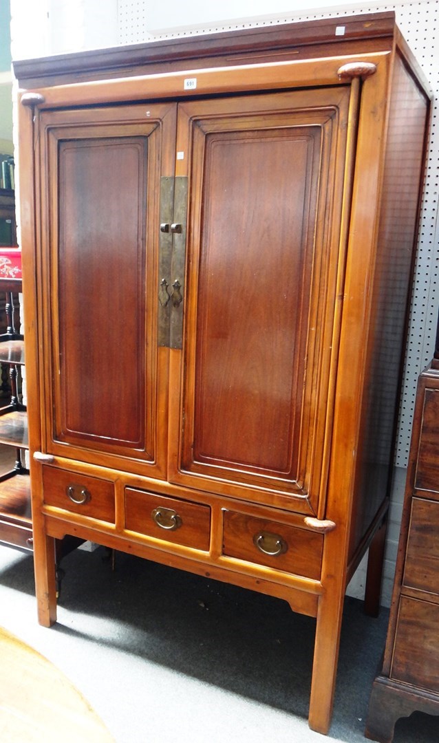 Appraisal: A th century Chinese softwood two door cupboard with three