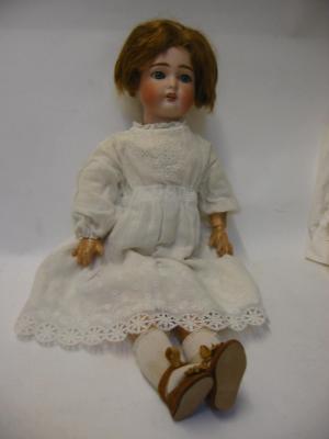 Appraisal: A German bisque head girl doll with blue glass sleeping