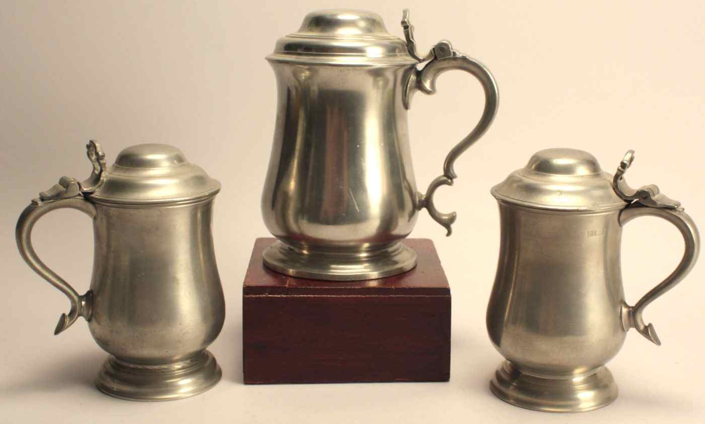 Appraisal: THREE ANTIQUE ENGLISH PEWTER LIDDED TANKARDS th CenturyOne height others