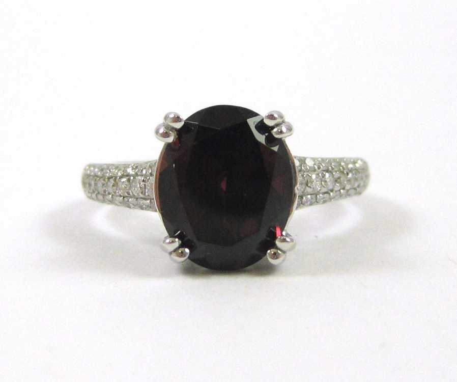 Appraisal: GARNET DIAMOND AND FOURTEEN KARAT GOLD RING The white gold