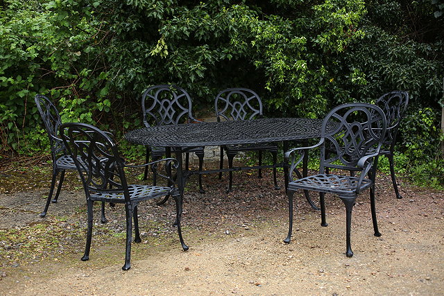 Appraisal: A BLACK PAINTED GARDEN TABLE the pierced top with rounded