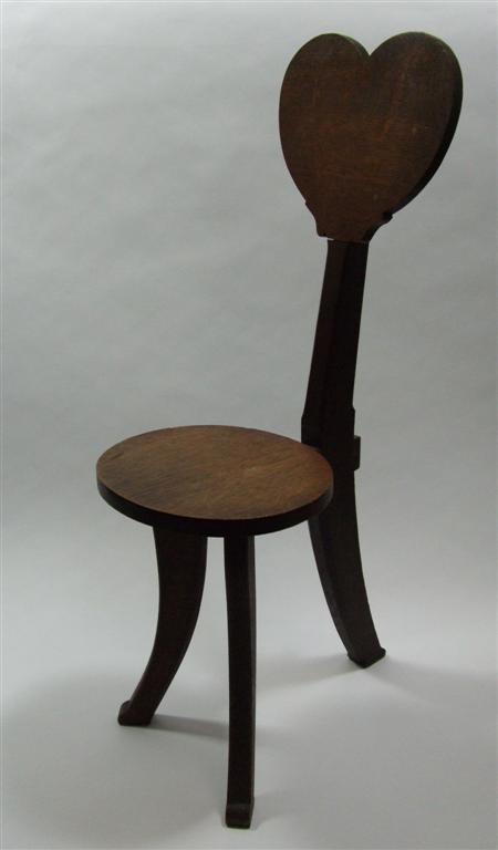 Appraisal: SCOTTISH ARTS AND CRAFTS SPINNING CHAIR CIRCA oak with heart-shaped