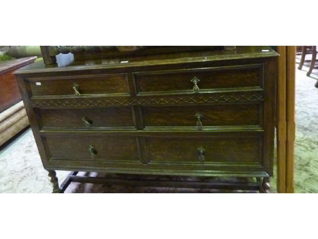 Appraisal: An Edwardian oak dressing chest fitted with two long and