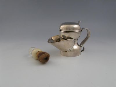 Appraisal: A late Victorian shaving jug with hinged cover brush rest