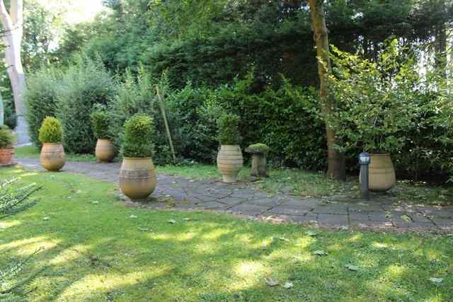 Appraisal: A TERRACOTTA OVOID PLANTER with ribbed decoration and three loop