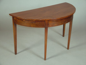 Appraisal: A mahogany demi-lune side table th century upon tapering square