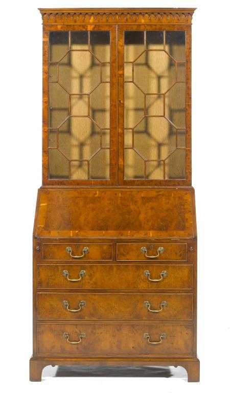 Appraisal: A YEW-WOOD BUREAU-BOOKCASE in George III style with glazed doors