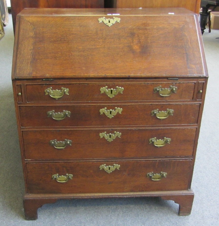 Appraisal: An th century oak bureau the fitted interior over four