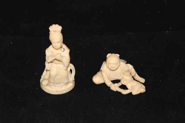 Appraisal: A SMALL JAPANESE IVORY CARVED FIGURAL GROUP high together with