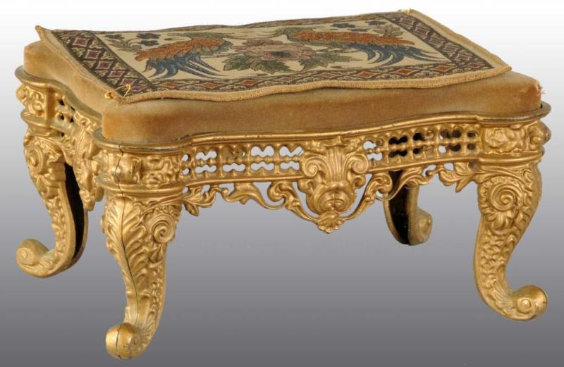 Appraisal: Victorian Brass Footstool Description With cushion and tapestry on top