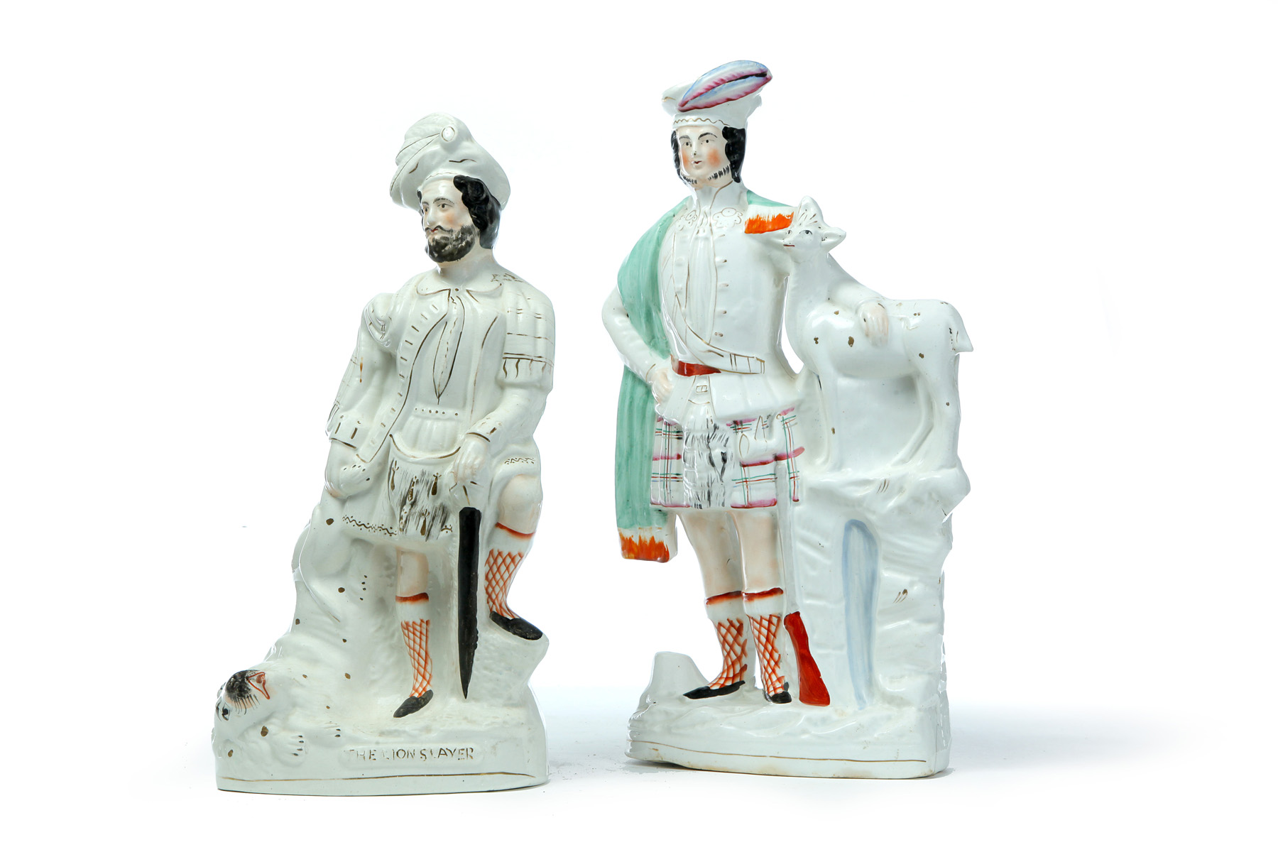 Appraisal: TWO STAFFORDSHIRE FIGURES OF SCOTSMEN England mid th century The