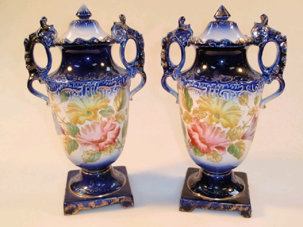 Appraisal: A pair of Staffordshire floral vases with flow blue bands