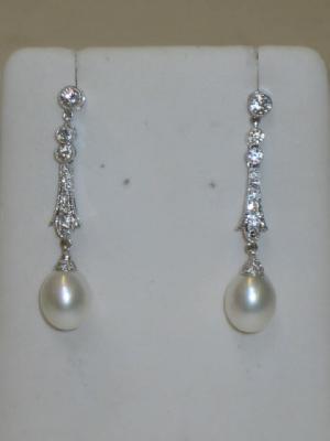 Appraisal: A PAIR OF CULTURED PEARL AND DIAMOND EARRINGS the pearl