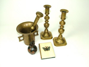 Appraisal: A bronze pestle and mortar a pair of brass candlesticks