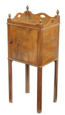 Appraisal: A th century mahogany bedside cupboard the galleried top with