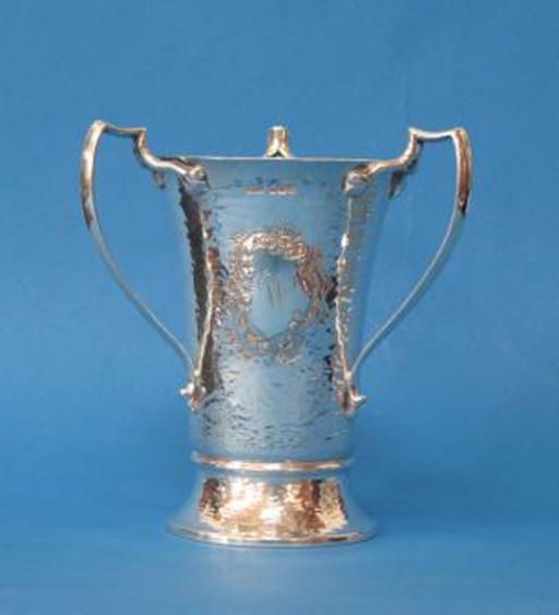 Appraisal: A GEORGE V THREE HANDLED CUP of tapering circular form