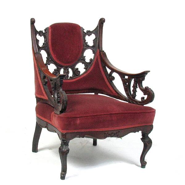 Appraisal: A Gothic style carved mahogany and upholstered armchair height in