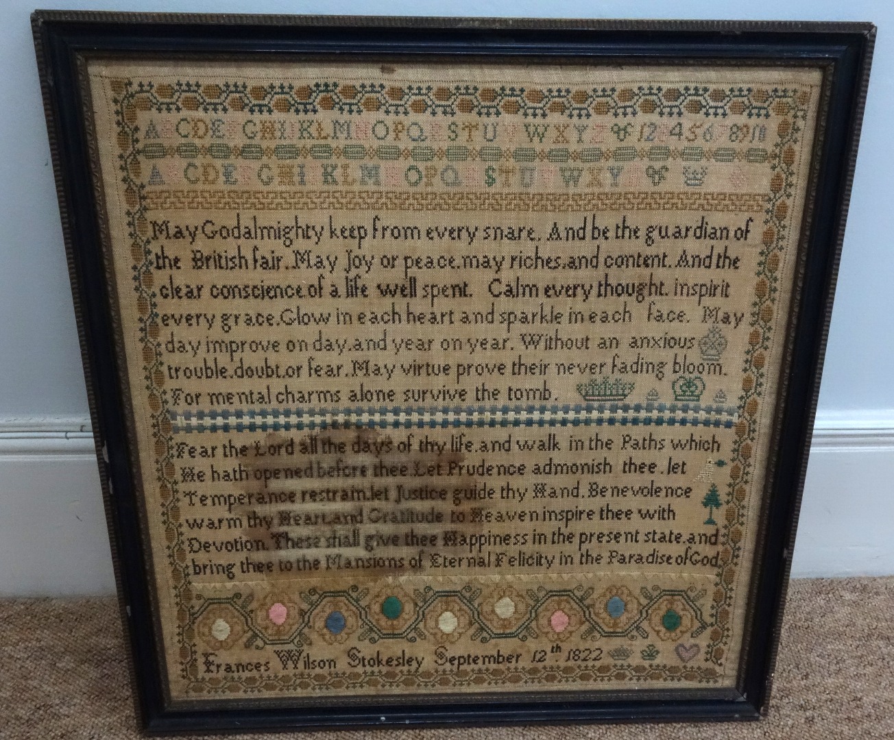 Appraisal: A needlework sampler worked with alphabet numerals and religious text