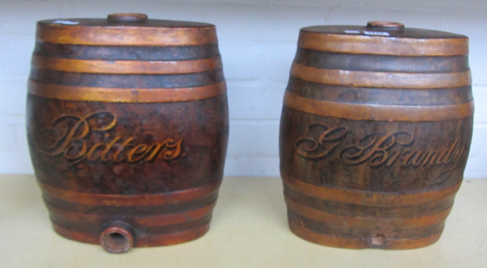 Appraisal: A pair of painted stoneware barrels 'G Brandy Bitters' stamped