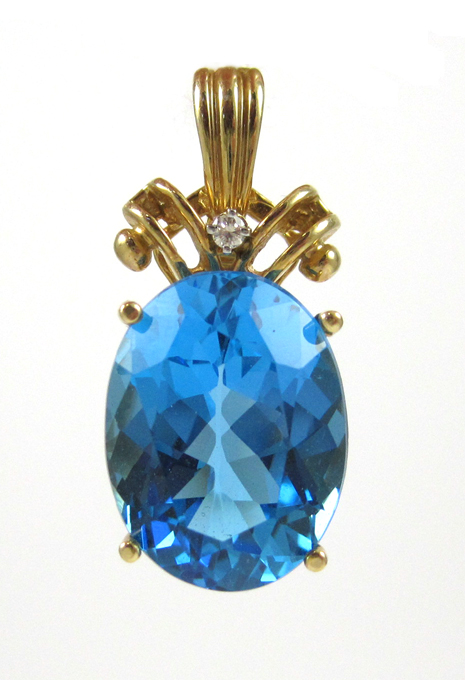 Appraisal: BLUE TOPAZ AND FOURTEEN KARAT GOLD PENDANT with one round-cut