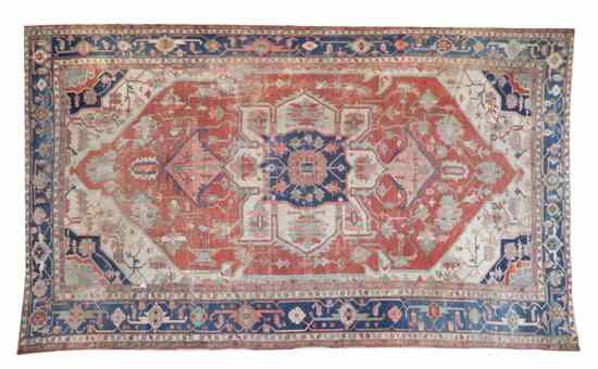 Appraisal: A Persian Wool Rug having a foliate center medallion surrounded