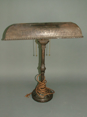 Appraisal: An wrought iron desk lamp in the style of E