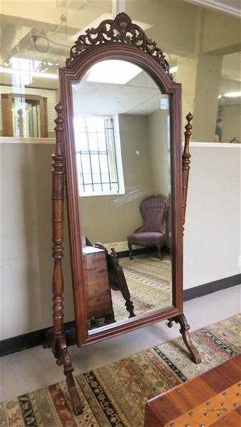 Appraisal: A VICTORIAN STYLE MAHOGANY CHEVAL MIRROR a tall dressing mirror