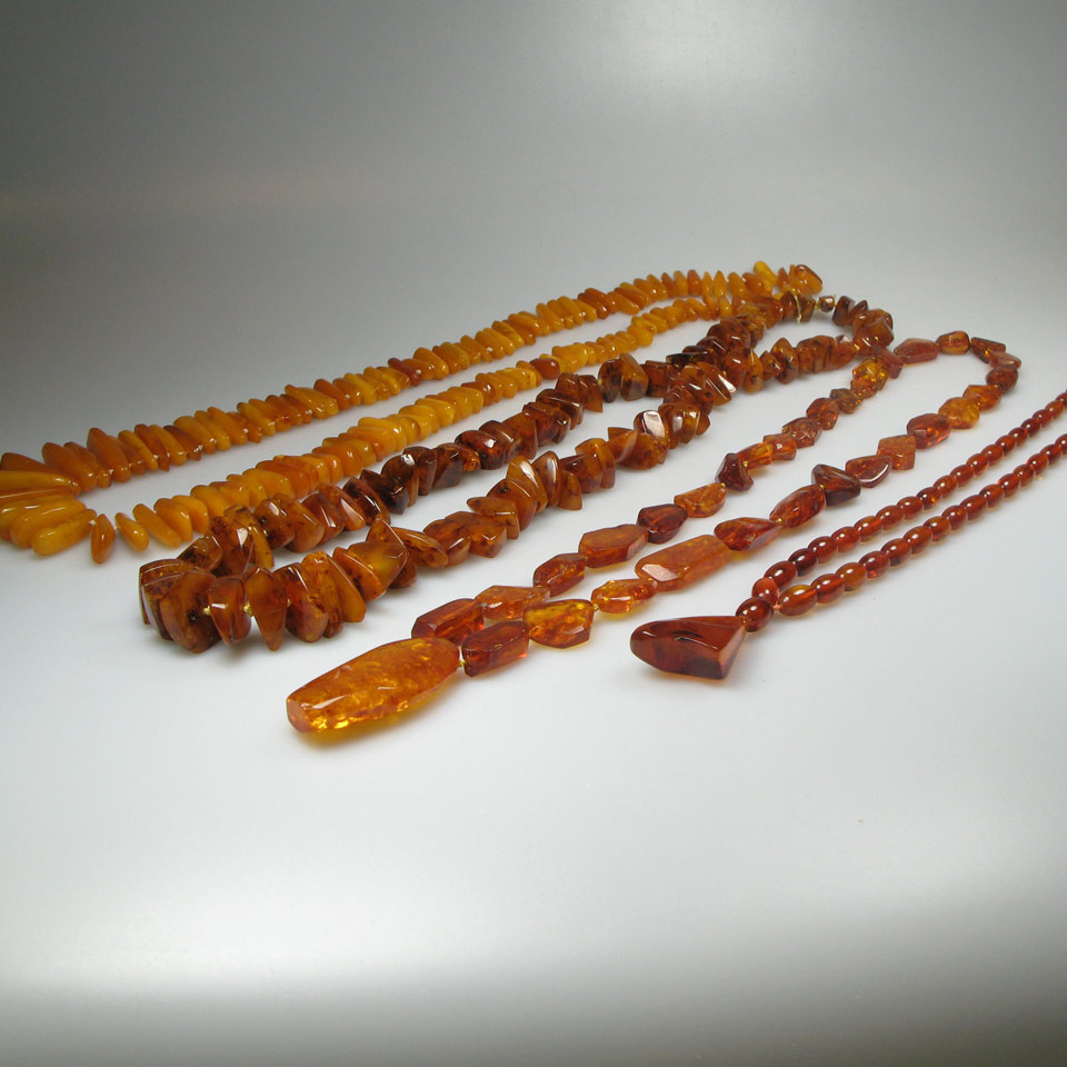 Appraisal: Strands Of Amber Beads and an amber brooch