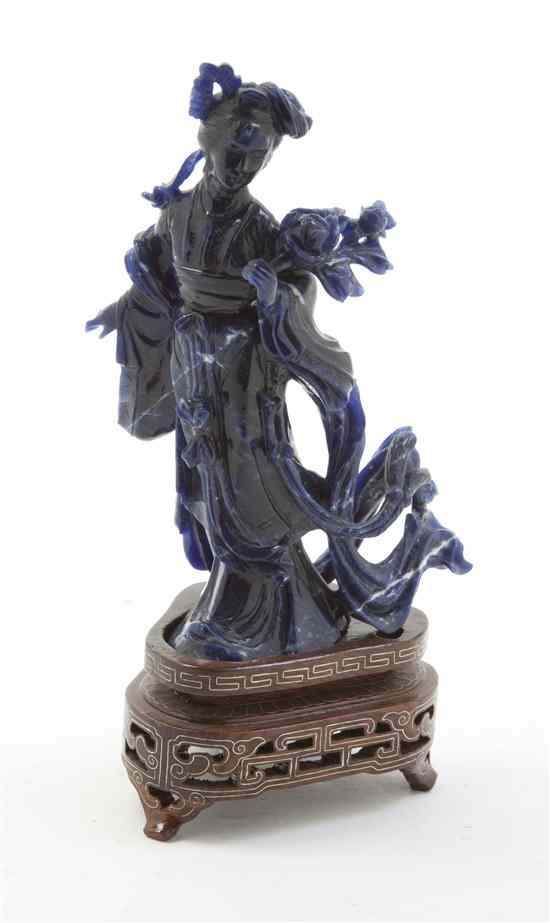 Appraisal: A Chinese Lapis Figural Carving depicting a standing beauty holding