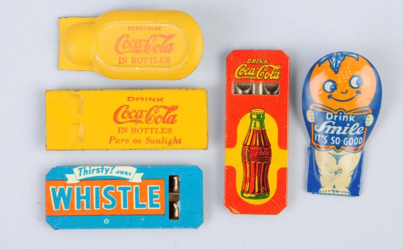 Appraisal: Lot Of Soda Advertising Clickers Whistle This lot includes two