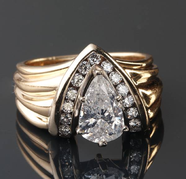 Appraisal: A pear shape diamond diamond and k gold ring central